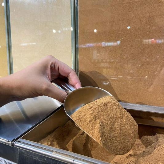 Pa-cheia-de-canela-em-po-exposta-em-um-recipiente-a-granel